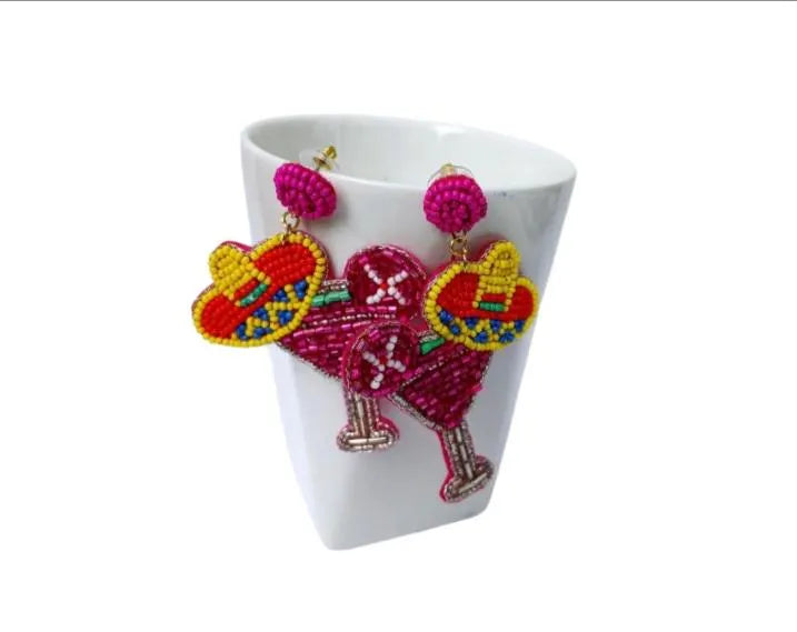 Pink Margarita Beaded Dangle Earrings shaped like festive sombreros, featuring bright yellow beads and playful, bold design. These handmade novelty statement earrings are perfect for costume parties, themed events, or adding a fun pop of color to any outfit. Lightweight and eye-catching, they make a unique gift for women who love quirky, artisanal jewelry with vibrant personality and festive flair.