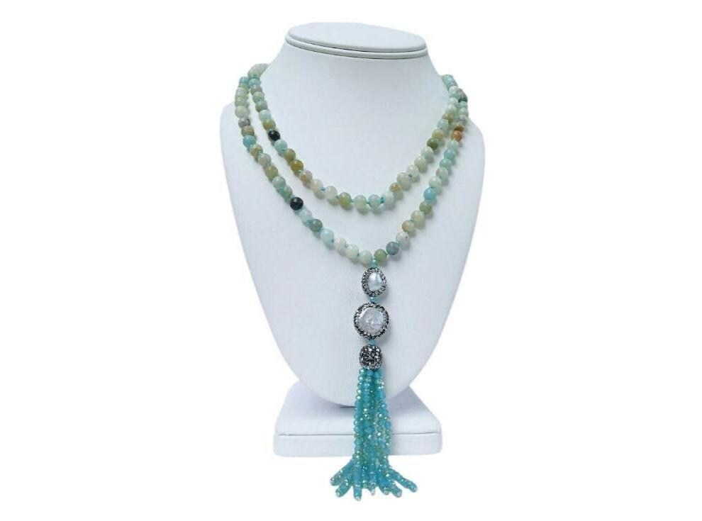 Amazonite and Pearl Necklace featuring handmade beaded crystals crafted into a bohemian long necklace with yoga charm beads and tassel accents. This unique jewelry piece blends soothing amazonite stones with elegant pearls, creating a versatile accessory perfect for spiritual practice or everyday wear. Lightweight and stylish, it makes a thoughtful gift for her, combining artisanal craftsmanship with calming energy and boho-chic design for women who appreciate meaningful jewelry.