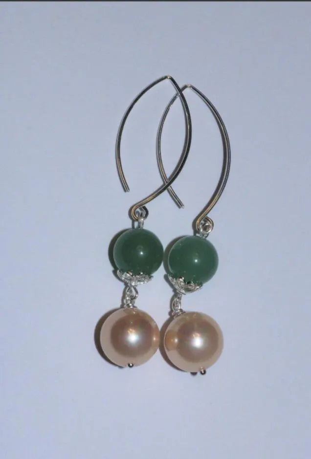 Green Aventurine Earrings with Freshwater Pearl Dangles handcrafted in sterling silver for an elegant, timeless look. These earrings feature natural green aventurine stones paired with lustrous freshwater pearls, symbolizing luck, prosperity, and calm energy. Perfect for adding a touch of sophistication to any outfit, they make a thoughtful gift for women who appreciate handmade gemstone jewelry, natural healing crystals, and classic accessories that blend beauty with spiritual balance.
