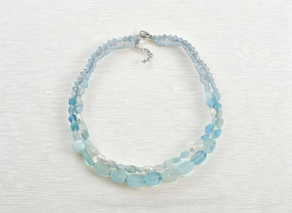 Elegant Aquamarine Necklace featuring natural aquamarine gemstones paired with lustrous freshwater pearls and secured with a sterling silver clasp. This handcrafted jewelry piece combines calming blue tones with classic pearl elegance, creating a versatile accessory for everyday wear or special occasions. Perfect as a thoughtful gift for her, this necklace embodies sophistication, serenity, and artisanal craftsmanship, making it ideal for birthdays, anniversaries, or meaningful celebrations.