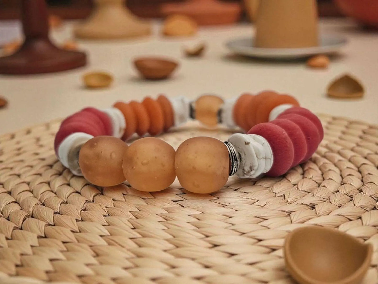 African Ashanti Glass Beaded Bracelet featuring large chunky beads in vibrant orange, red, and white colors, handcrafted into a bold statement jewelry piece for women. This lucky charm Buddha bracelet blends traditional African craftsmanship with modern style, promoting positive energy and spiritual protection. Perfect as a unique gift for her, it combines artisanal quality with eye-catching colors, ideal for everyday wear or special occasions.
