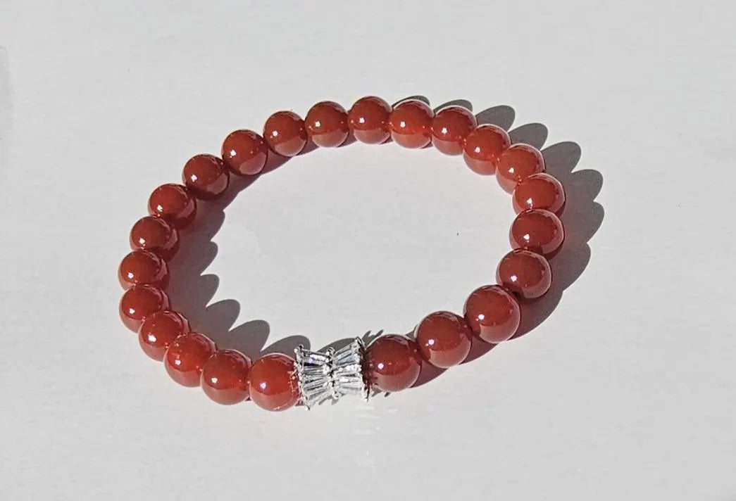 Carnelian bracelet featuring polished orange-red healing crystals on a handmade beaded strand. A vibrant energy-boosting crystal jewelry piece designed for women, ideal as a spiritual, healing, or meaningful gift.