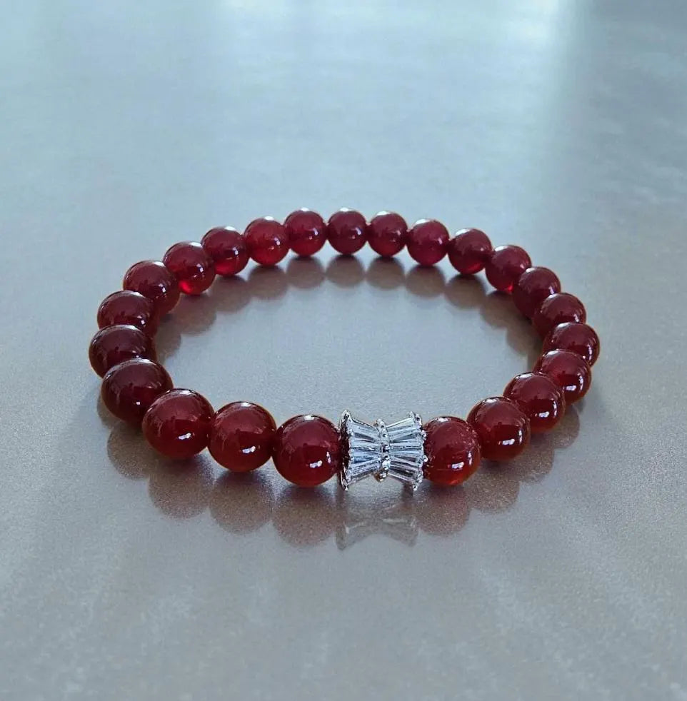 Carnelian bracelet featuring polished orange-red healing crystals on a handmade beaded strand. A vibrant energy-boosting crystal jewelry piece designed for women, ideal as a spiritual, healing, or meaningful gift.