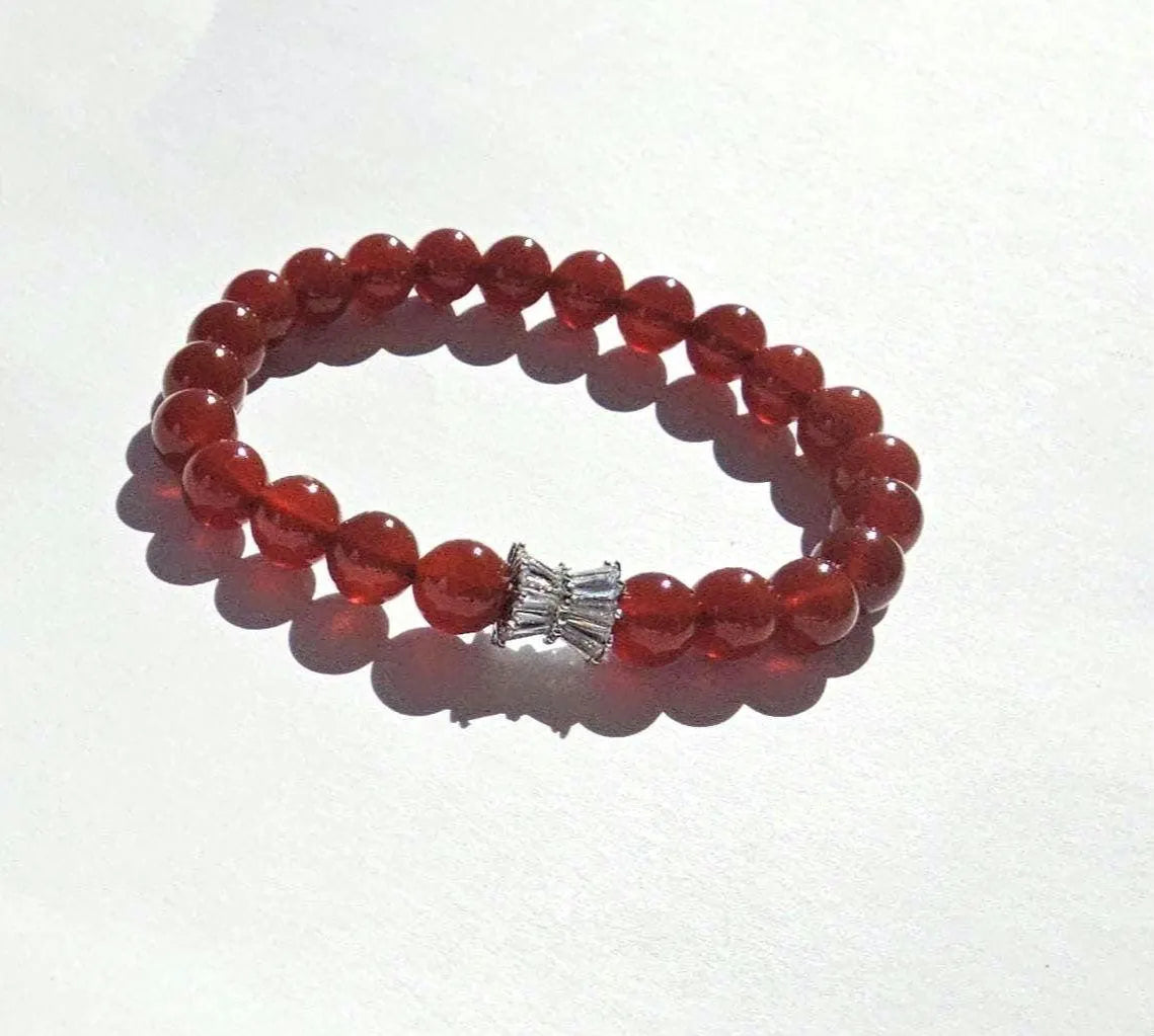 Carnelian bracelet featuring polished orange-red healing crystals on a handmade beaded strand. A vibrant energy-boosting crystal jewelry piece designed for women, ideal as a spiritual, healing, or meaningful gift.