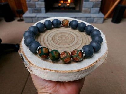 Gray Hematite Bracelet featuring Tibetan Agate accents, handcrafted as a crystal healing jewelry piece for men. This lucky charm bracelet combines the grounding energy of hematite with the protective properties of Tibetan agate, promoting balance and spiritual wellness. Lightweight and stylish, it makes a meaningful gift for him, perfect for everyday wear or meditation. Unique Tibetan-inspired design blends artisanal craftsmanship with natural healing stones.