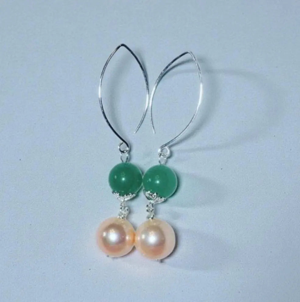 Green Aventurine Earrings with Freshwater Pearl Dangles handcrafted in sterling silver for an elegant, timeless look. These earrings feature natural green aventurine stones paired with lustrous freshwater pearls, symbolizing luck, prosperity, and calm energy. Perfect for adding a touch of sophistication to any outfit, they make a thoughtful gift for women who appreciate handmade gemstone jewelry, natural healing crystals, and classic accessories that blend beauty with spiritual balance.