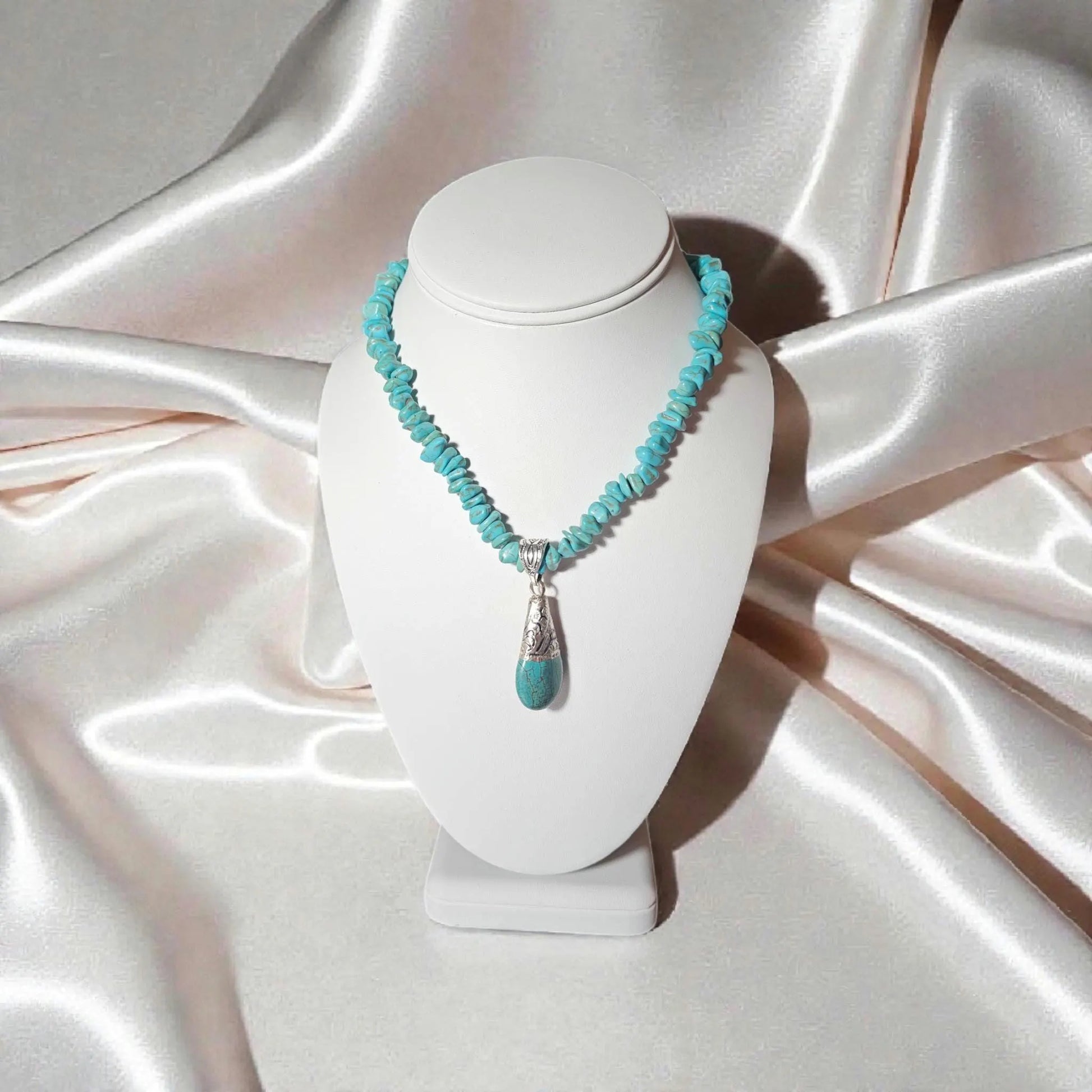 Turquoise Necklace featuring a handcrafted Tibetan turquoise pendant with contemporary repoussé design. This artisan necklace combines vibrant turquoise stones with intricate metalwork for a striking boho-chic statement piece. Perfect for everyday wear, festivals, or special occasions, it makes a thoughtful gift for women who love handcrafted jewelry, cultural-inspired designs, and unique accessories that blend natural beauty, artistic craftsmanship, and meaningful style.