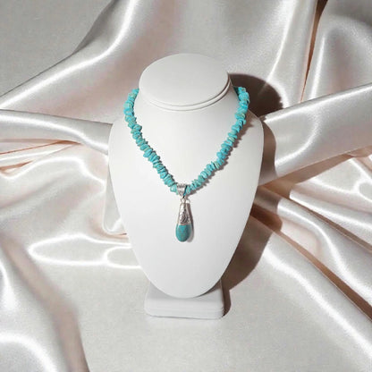 Turquoise Necklace featuring a handcrafted Tibetan turquoise pendant with contemporary repoussé design. This artisan necklace combines vibrant turquoise stones with intricate metalwork for a striking boho-chic statement piece. Perfect for everyday wear, festivals, or special occasions, it makes a thoughtful gift for women who love handcrafted jewelry, cultural-inspired designs, and unique accessories that blend natural beauty, artistic craftsmanship, and meaningful style.