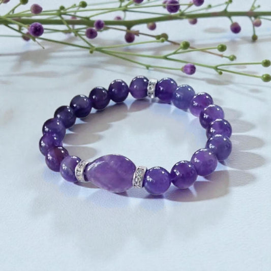 Amethyst Healing Bracelet handcrafted with natural amethyst and moonstone crystals, known for promoting happiness, healing, and spiritual balance. This elegant handmade bracelet combines calming purple tones with iridescent moonstone for a serene, empowering look. Ideal gift for her, this crystal jewelry piece supports emotional wellness and attracts positive energy. Perfect for birthdays, wellness gifts, or everyday wear with mindful intention.