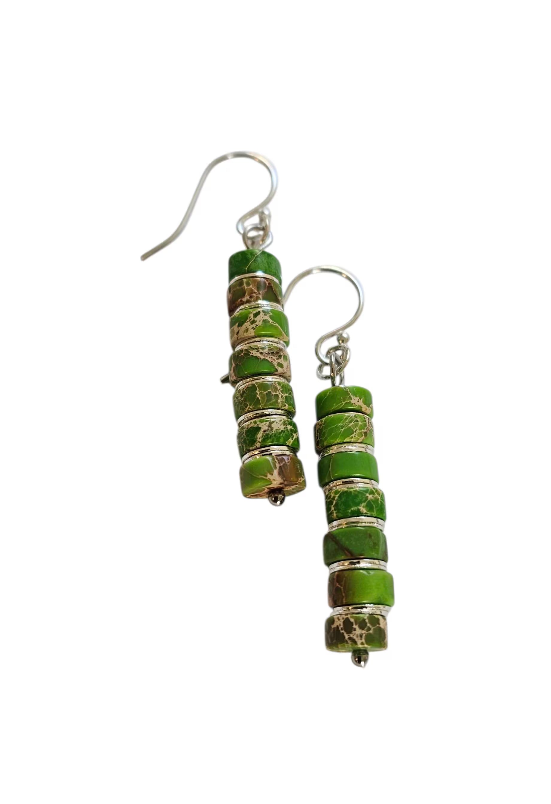 Green Jasper Dangle Earrings featuring natural green jasper stones set in sterling silver, handcrafted in a boho southwestern-inspired design. These elegant earrings showcase earthy tones and artisanal detail, perfect for adding a stylish, versatile touch to casual or festival outfits. Ideal as a thoughtful gift for women who appreciate handmade gemstone jewelry, bohemian fashion, and unique statement accessories that combine natural beauty, spiritual energy, and timeless artisan craftsmanship.