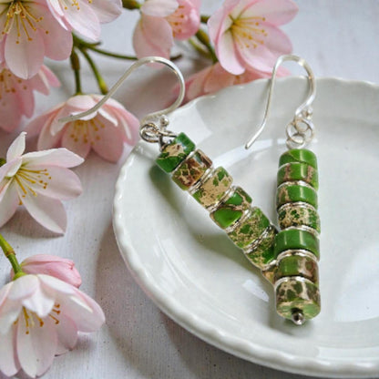 Green Jasper Dangle Earrings featuring natural green jasper stones set in sterling silver, handcrafted in a boho southwestern-inspired design. These elegant earrings showcase earthy tones and artisanal detail, perfect for adding a stylish, versatile touch to casual or festival outfits. Ideal as a thoughtful gift for women who appreciate handmade gemstone jewelry, bohemian fashion, and unique statement accessories that combine natural beauty, spiritual energy, and timeless artisan craftsmanship.