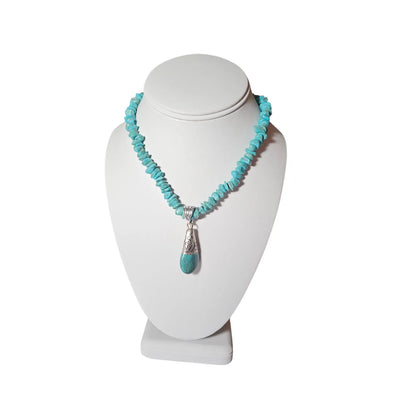 Turquoise Necklace featuring a handcrafted Tibetan turquoise pendant with contemporary repoussé design. This artisan necklace combines vibrant turquoise stones with intricate metalwork for a striking boho-chic statement piece. Perfect for everyday wear, festivals, or special occasions, it makes a thoughtful gift for women who love handcrafted jewelry, cultural-inspired designs, and unique accessories that blend natural beauty, artistic craftsmanship, and meaningful style.