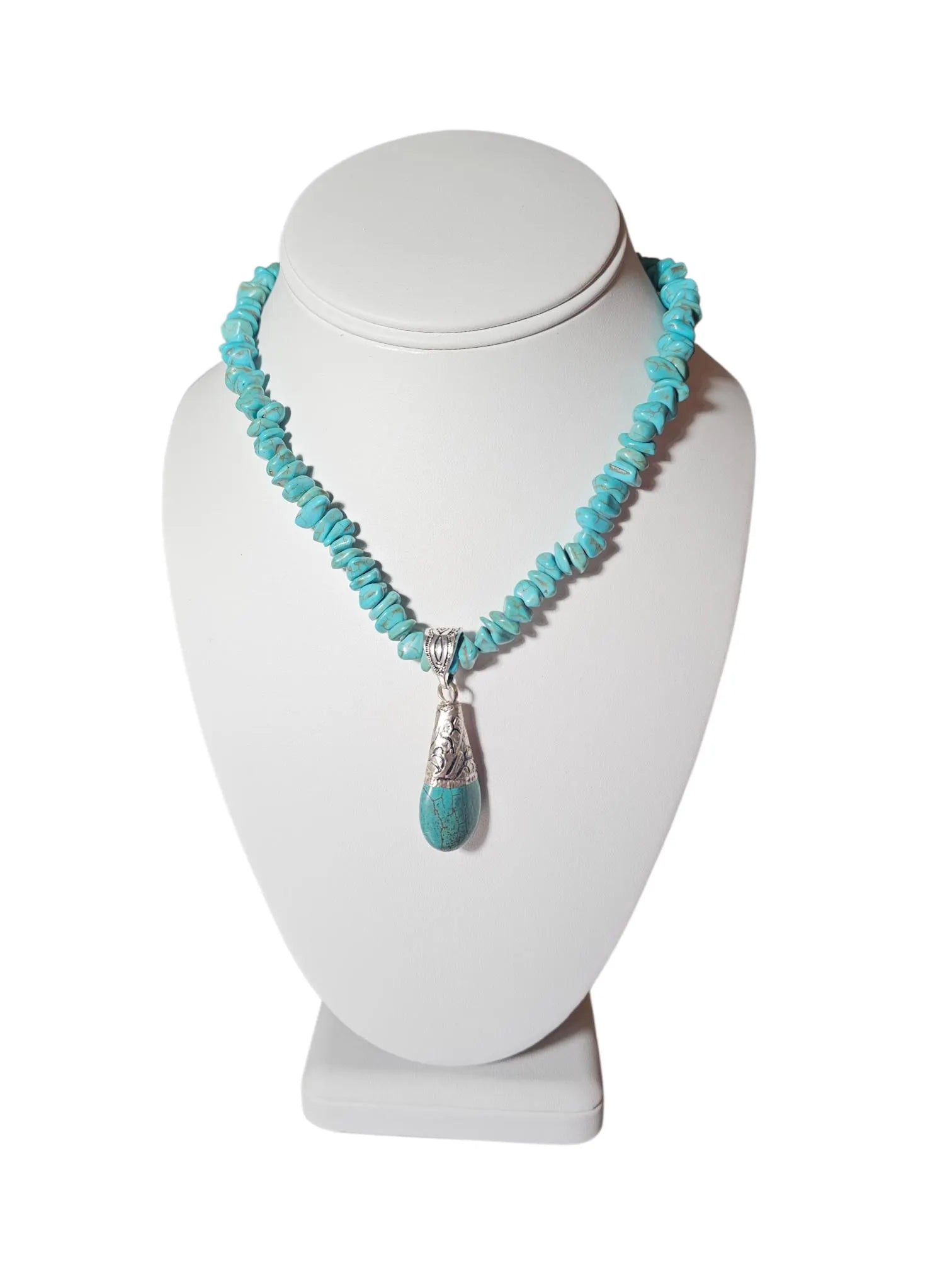 Turquoise Necklace featuring a handcrafted Tibetan turquoise pendant with contemporary repoussé design. This artisan necklace combines vibrant turquoise stones with intricate metalwork for a striking boho-chic statement piece. Perfect for everyday wear, festivals, or special occasions, it makes a thoughtful gift for women who love handcrafted jewelry, cultural-inspired designs, and unique accessories that blend natural beauty, artistic craftsmanship, and meaningful style.