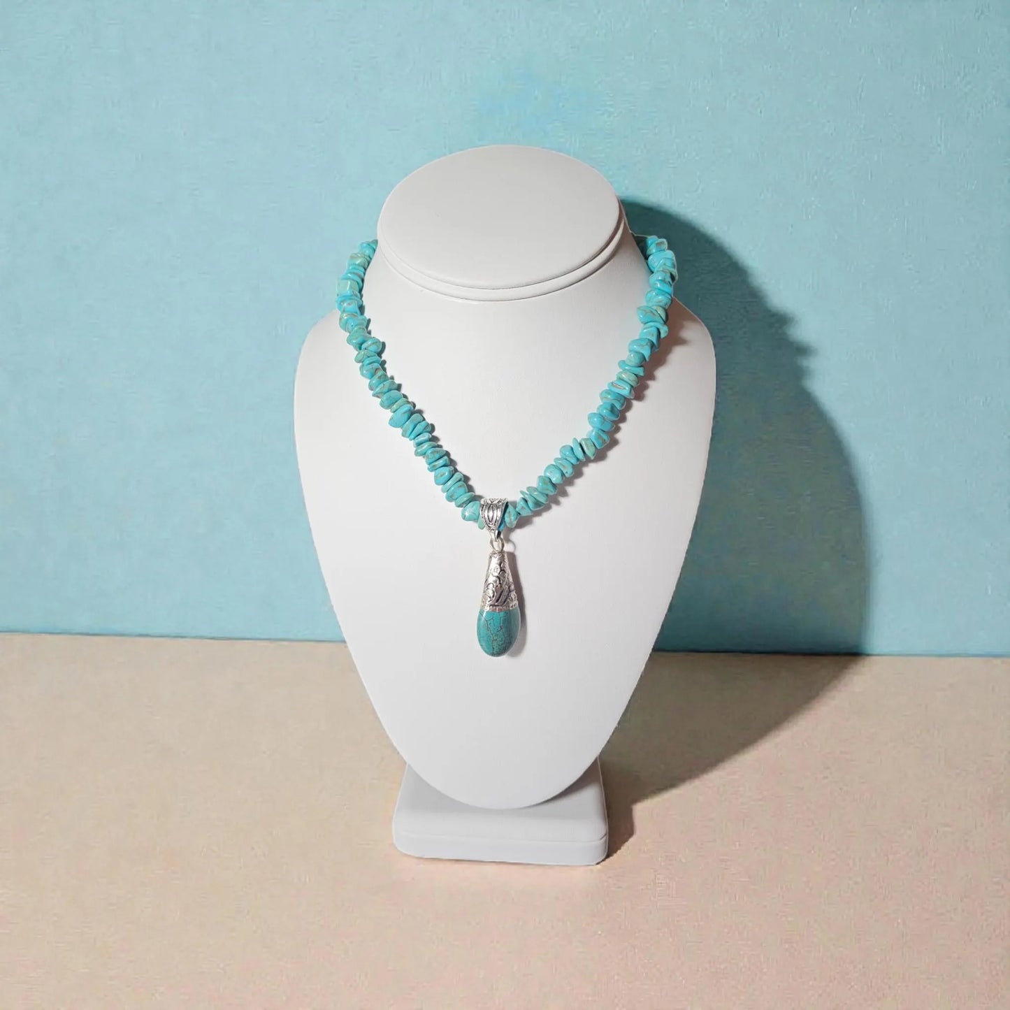 Turquoise Necklace featuring a handcrafted Tibetan turquoise pendant with contemporary repoussé design. This artisan necklace combines vibrant turquoise stones with intricate metalwork for a striking boho-chic statement piece. Perfect for everyday wear, festivals, or special occasions, it makes a thoughtful gift for women who love handcrafted jewelry, cultural-inspired designs, and unique accessories that blend natural beauty, artistic craftsmanship, and meaningful style.