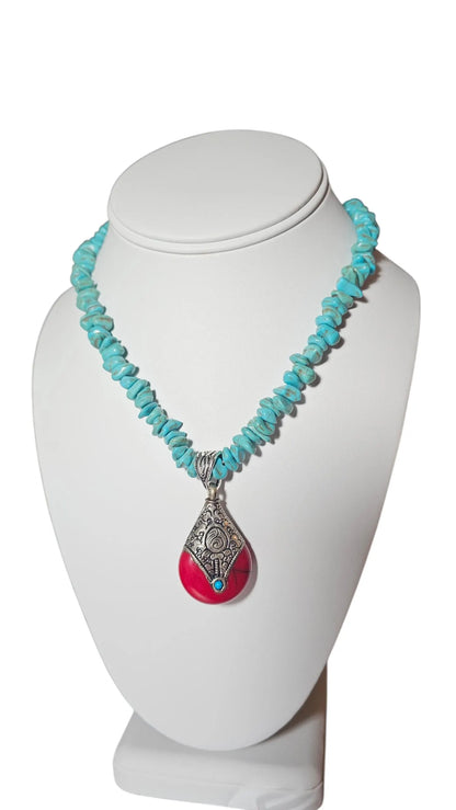 Turquoise Necklace featuring a handmade Tibetan red crackle silver pendant crafted with contemporary repoussé techniques. This unique necklace combines vibrant turquoise stones with intricate artisan metalwork for a bold, statement accessory. Perfect for everyday wear, boho-chic outfits, or special occasions, it makes a thoughtful gift for women who appreciate handcrafted jewelry, cultural designs, and one-of-a-kind pieces that blend color, texture, and artistic craftsmanship.