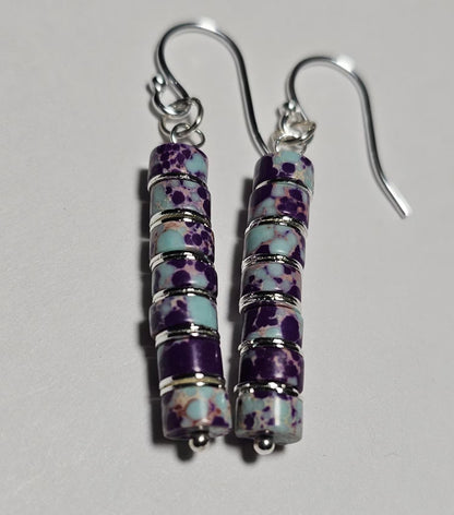 Purple jasper dangle earrings crafted with natural jasper stones and sterling silver hooks, featuring rich purple tones and earthy patterns. These boho southwestern style earrings are handmade to highlight the unique character of each stone, creating a lightweight yet eye-catching accessory. Perfect for everyday wear or special occasions, they make a thoughtful gift for women who love artisan jewelry, natural gemstones, and bohemian or southwestern inspired fashion.
