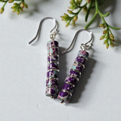 Purple jasper dangle earrings crafted with natural jasper stones and sterling silver hooks, featuring rich purple tones and earthy patterns. These boho southwestern style earrings are handmade to highlight the unique character of each stone, creating a lightweight yet eye-catching accessory. Perfect for everyday wear or special occasions, they make a thoughtful gift for women who love artisan jewelry, natural gemstones, and bohemian or southwestern inspired fashion.