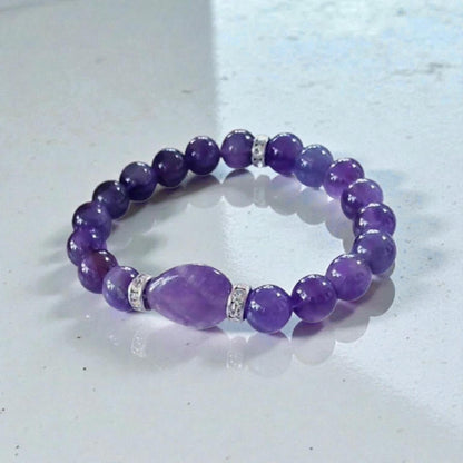 Amethyst Healing Bracelet handcrafted with natural amethyst and moonstone crystals, known for promoting happiness, healing, and spiritual balance. This elegant handmade bracelet combines calming purple tones with iridescent moonstone for a serene, empowering look. Ideal gift for her, this crystal jewelry piece supports emotional wellness and attracts positive energy. Perfect for birthdays, wellness gifts, or everyday wear with mindful intention.