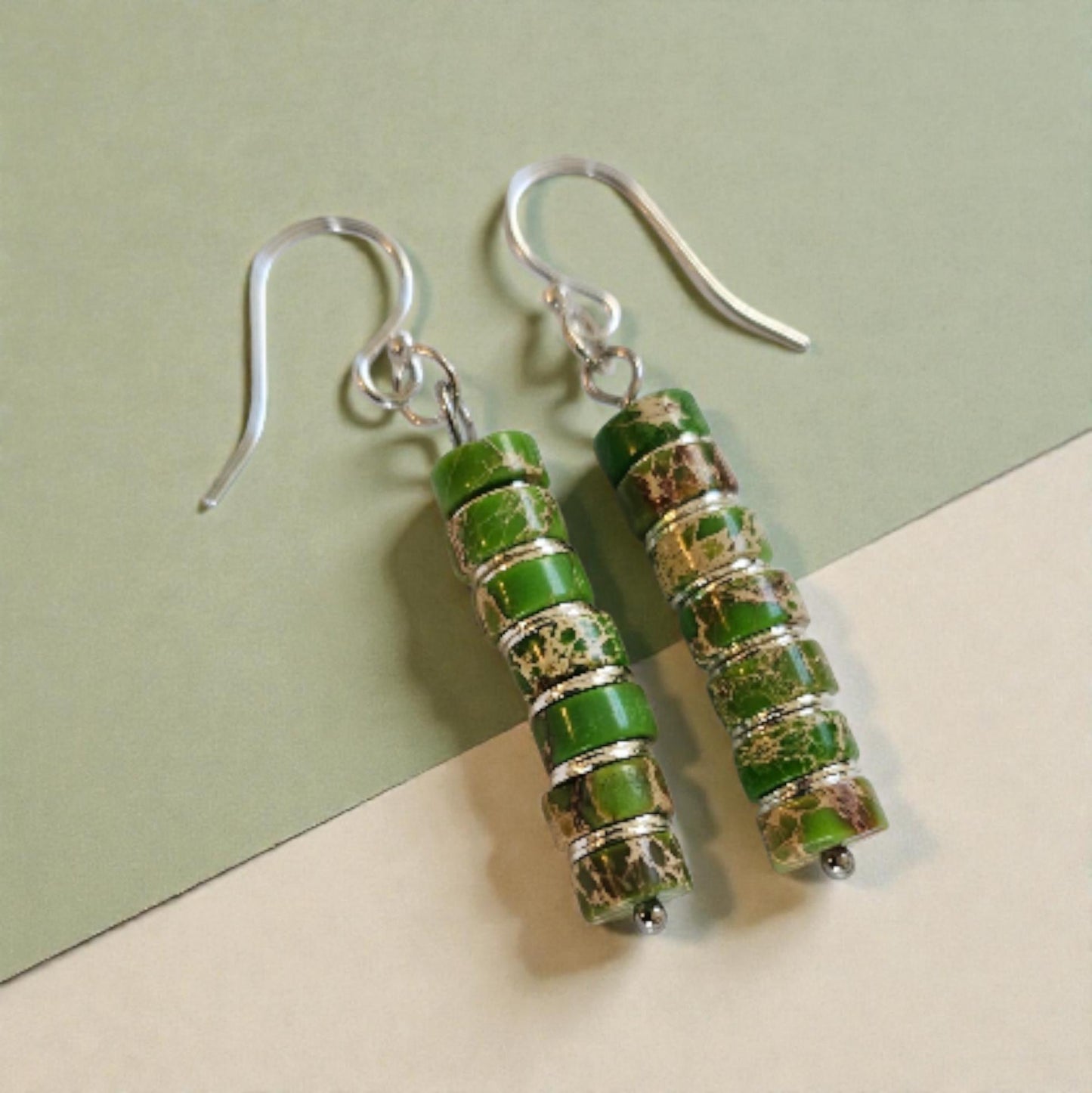 Green Jasper Dangle Earrings featuring natural green jasper stones set in sterling silver, handcrafted in a boho southwestern-inspired design. These elegant earrings showcase earthy tones and artisanal detail, perfect for adding a stylish, versatile touch to casual or festival outfits. Ideal as a thoughtful gift for women who appreciate handmade gemstone jewelry, bohemian fashion, and unique statement accessories that combine natural beauty, spiritual energy, and timeless artisan craftsmanship.