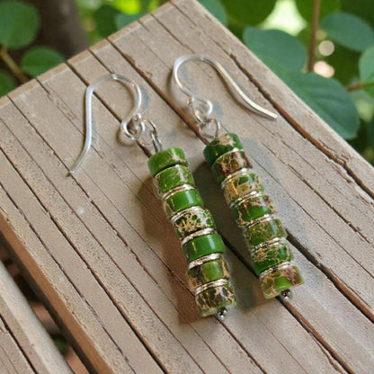 Green Jasper Dangle Earrings featuring natural green jasper stones set in sterling silver, handcrafted in a boho southwestern-inspired design. These elegant earrings showcase earthy tones and artisanal detail, perfect for adding a stylish, versatile touch to casual or festival outfits. Ideal as a thoughtful gift for women who appreciate handmade gemstone jewelry, bohemian fashion, and unique statement accessories that combine natural beauty, spiritual energy, and timeless artisan craftsmanship.