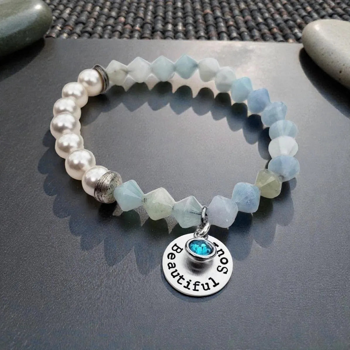 Aquamarine Pearl Bracelet featuring handmade beaded design combining soothing aquamarine stones with lustrous pearls. This inspirational jewelry piece is perfect as a March birthstone gift, symbolizing calmness, courage, and good luck. Ideal for her or as a thoughtful mother’s gift, it blends elegant style with meaningful healing properties. Lightweight and versatile, this bracelet adds a delicate, spiritual touch to everyday wear or special occasions, celebrating love and positive energy.