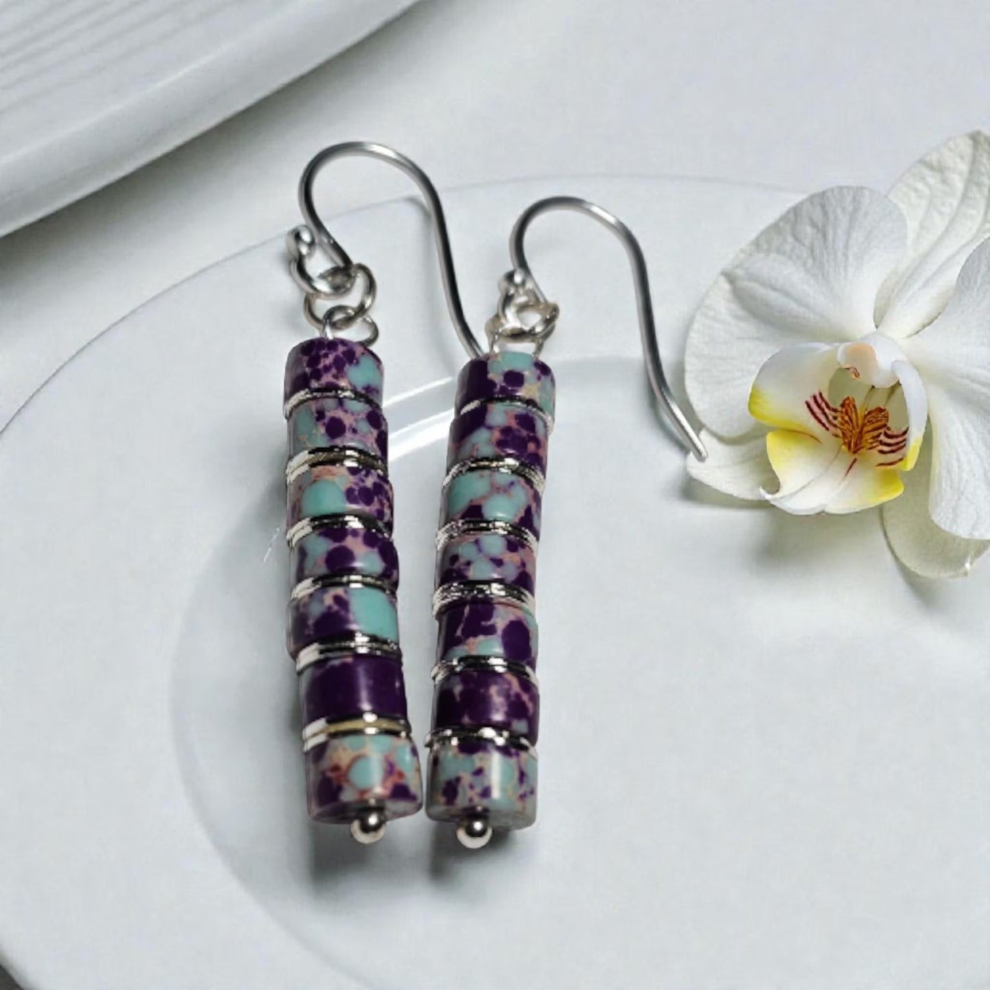 Purple jasper dangle earrings crafted with natural jasper stones and sterling silver hooks, featuring rich purple tones and earthy patterns. These boho southwestern style earrings are handmade to highlight the unique character of each stone, creating a lightweight yet eye-catching accessory. Perfect for everyday wear or special occasions, they make a thoughtful gift for women who love artisan jewelry, natural gemstones, and bohemian or southwestern inspired fashion.