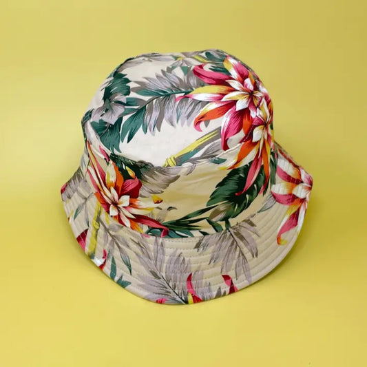 Khaki Floral Boho Hunter Bucket Hat featuring a stylish Hawaiian-inspired print, perfect for men and women seeking lightweight sun and rain protection. This unisex fisherman-style hat is ideal for travel, beach days, hiking, and other outdoor adventures. Designed for comfort and breathability, it combines boho charm with practical function. A versatile, packable accessory that adds flair to any casual outfit while keeping you shaded and dry.