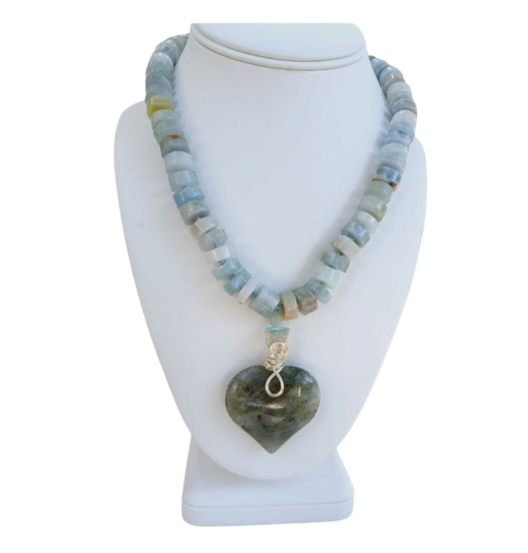 Labradorite Pendant Aquamarine Necklace featuring a statement heart-shaped pendant, handcrafted for women who love boho and spiritual jewelry. This unique necklace combines the mystical glow of labradorite with soothing aquamarine stones, creating a meaningful accessory that promotes intuition and calm energy. Perfect as a thoughtful handmade gift for her, it adds elegance and positive energy to any outfit, ideal for everyday wear or special occasions.