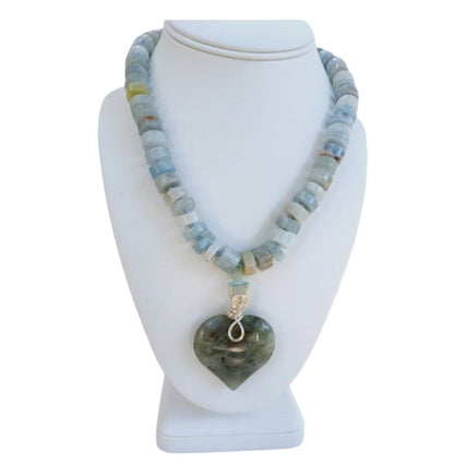 Labradorite Pendant Aquamarine Necklace featuring a statement heart-shaped pendant, handcrafted for women who love boho and spiritual jewelry. This unique necklace combines the mystical glow of labradorite with soothing aquamarine stones, creating a meaningful accessory that promotes intuition and calm energy. Perfect as a thoughtful handmade gift for her, it adds elegance and positive energy to any outfit, ideal for everyday wear or special occasions.