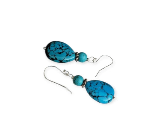 Large Blue Howlite Turquoise Earrings featuring sterling silver dangle design inspired by Native American style. These bold statement earrings showcase vibrant blue howlite stones paired with intricate silverwork, perfect for women who appreciate handcrafted artisan jewelry with cultural significance. Lightweight yet eye-catching, they make an ideal gift for her, adding a touch of boho elegance and natural beauty to any outfit, suitable for festivals, special occasions, or everyday wear.