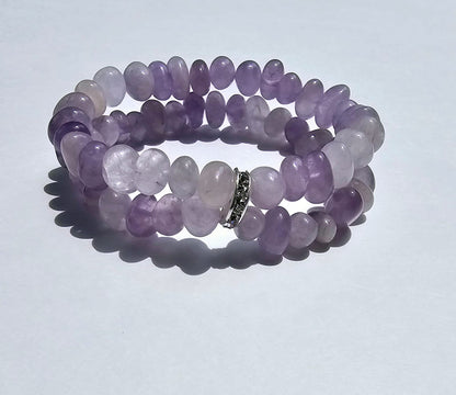 Amethyst Bracelet for Women featuring delicate lavender crystal beads handcrafted into a beautiful healing bracelet. This handmade beaded jewelry piece is designed to promote calm, balance, and spiritual well-being. Suitable as a meaningful gift for both men and women, it blends elegant style with natural energy. Perfect for everyday wear, meditation, or as a thoughtful spiritual accessory, this bracelet highlights the beauty and power of amethyst crystals in a versatile, artisanal design.