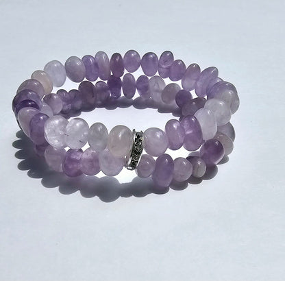 Amethyst Bracelet for Women featuring delicate lavender crystal beads handcrafted into a beautiful healing bracelet. This handmade beaded jewelry piece is designed to promote calm, balance, and spiritual well-being. Suitable as a meaningful gift for both men and women, it blends elegant style with natural energy. Perfect for everyday wear, meditation, or as a thoughtful spiritual accessory, this bracelet highlights the beauty and power of amethyst crystals in a versatile, artisanal design.