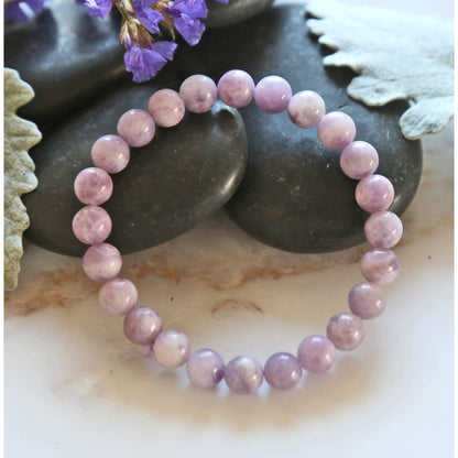 Elegant lavender Jadeite stretch bracelet for women featuring 8mm smooth beads, designed as a lucky healing stone jewelry piece. This adjustable one-size bracelet offers both comfort and style, promoting balance and positive energy. Perfect as a meaningful gift for her, it combines natural beauty and spiritual benefits in a versatile accessory ideal for everyday wear or special occasions, handmade with care.