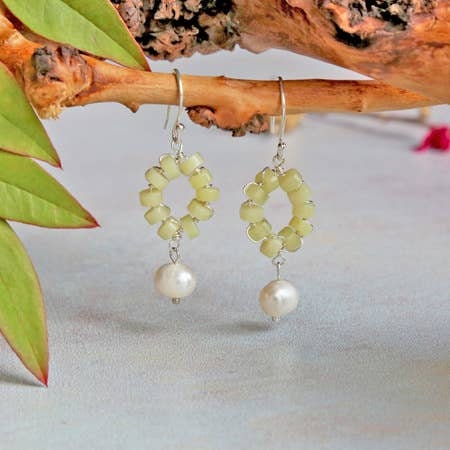 Handmade hoop earrings featuring cultured freshwater pearls and vibrant lemon jade beads, beautifully combining elegance and natural healing properties. These gemstone earrings are perfect for women who appreciate unique, handcrafted jewelry with a touch of boho charm. Ideal as a bridesmaid gift or special occasion accessory, these delicate pearl and jade earrings bring a fresh, stylish look infused with calming crystal energy.