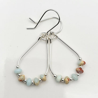 Light Blue Jasper Sterling Silver Earrings featuring handmade amazonite teardrop hoops designed for women who love elegant, natural blue jewelry. These artisanal earrings blend soothing jasper and amazonite stones with sterling silver craftsmanship, creating a delicate yet eye-catching accessory. Perfect as a gift for her or a bridesmaid gift, they add a calming, stylish touch to any outfit, ideal for everyday wear or special occasions with a boho-chic flair.