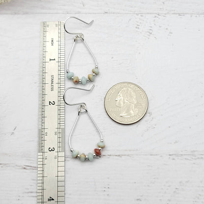 Light Blue Jasper Sterling Silver Earrings featuring handmade amazonite teardrop hoops designed for women who love elegant, natural blue jewelry. These artisanal earrings blend soothing jasper and amazonite stones with sterling silver craftsmanship, creating a delicate yet eye-catching accessory. Perfect as a gift for her or a bridesmaid gift, they add a calming, stylish touch to any outfit, ideal for everyday wear or special occasions with a boho-chic flair.
