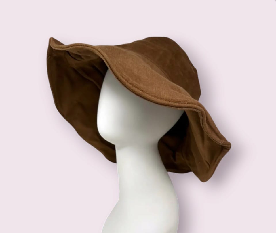 Summer linen bucket hat made from lightweight, breathable hemp fabric for all-day comfort and sun protection. This wide brim brown hat features a soft texture and boho chic style, perfect for women seeking a stylish yet functional accessory for the beach, travel, or daily wear. Designed to shield from harmful UV rays while complementing casual and bohemian outfits. Stay cool, protected, and fashionable this summer.