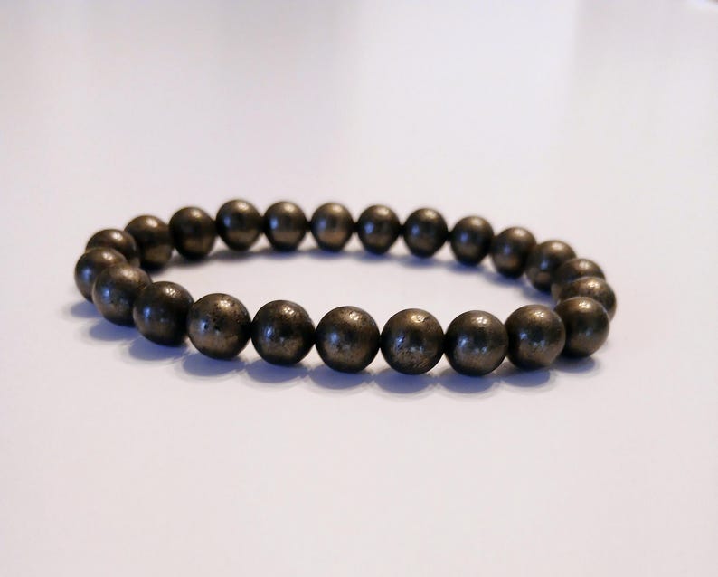 Good Luck Pyrite Bracelet featuring handmade crystal beads designed to attract abundance and positive spiritual energy. This unisex bracelet combines shimmering pyrite stones with artisanal craftsmanship, making it a meaningful gift for both women and men. Lightweight and stylish, it promotes confidence, prosperity, and protection. Perfect for everyday wear or meditation, this abundance bracelet blends healing properties with modern boho jewelry aesthetics.