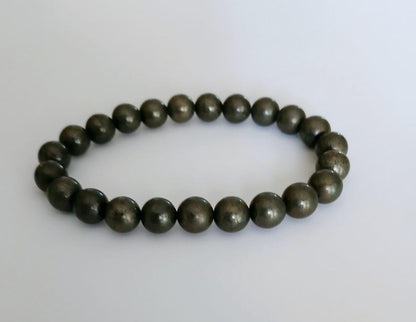 Good Luck Pyrite Bracelet featuring handmade crystal beads designed to attract abundance and positive spiritual energy. This unisex bracelet combines shimmering pyrite stones with artisanal craftsmanship, making it a meaningful gift for both women and men. Lightweight and stylish, it promotes confidence, prosperity, and protection. Perfect for everyday wear or meditation, this abundance bracelet blends healing properties with modern boho jewelry aesthetics.