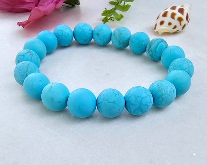 Magnesite Turquoise Stretch Bracelet designed for women and men, featuring blue stone beads known for their healing and chakra-balancing properties. This handcrafted boho crystal jewelry offers both style and spiritual energy, perfect for those seeking natural wellness accessories. Lightweight and comfortable, it makes a thoughtful gift that promotes calmness, positivity, and balance. Ideal for everyday wear, meditation, or adding a vibrant, earthy touch to any outfit.