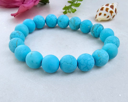 Magnesite Turquoise Stretch Bracelet designed for women and men, featuring blue stone beads known for their healing and chakra-balancing properties. This handcrafted boho crystal jewelry offers both style and spiritual energy, perfect for those seeking natural wellness accessories. Lightweight and comfortable, it makes a thoughtful gift that promotes calmness, positivity, and balance. Ideal for everyday wear, meditation, or adding a vibrant, earthy touch to any outfit.