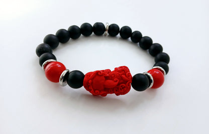 Pixiu Bracelet for men featuring red cinnabar and black onyx beads, designed as a powerful Feng Shui jewelry piece to attract abundance, wealth, and good luck. Inspired by the dragon zodiac, this handmade bracelet symbolizes protection and prosperity. Perfect as a meaningful gift for him, it combines spiritual energy with stylish craftsmanship. Ideal for daily wear or special occasions, enhancing confidence and positive vibes.