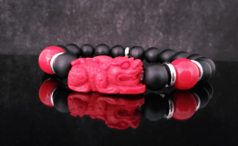 Pixiu Bracelet for men featuring red cinnabar and black onyx beads, designed as a powerful Feng Shui jewelry piece to attract abundance, wealth, and good luck. Inspired by the dragon zodiac, this handmade bracelet symbolizes protection and prosperity. Perfect as a meaningful gift for him, it combines spiritual energy with stylish craftsmanship. Ideal for daily wear or special occasions, enhancing confidence and positive vibes.