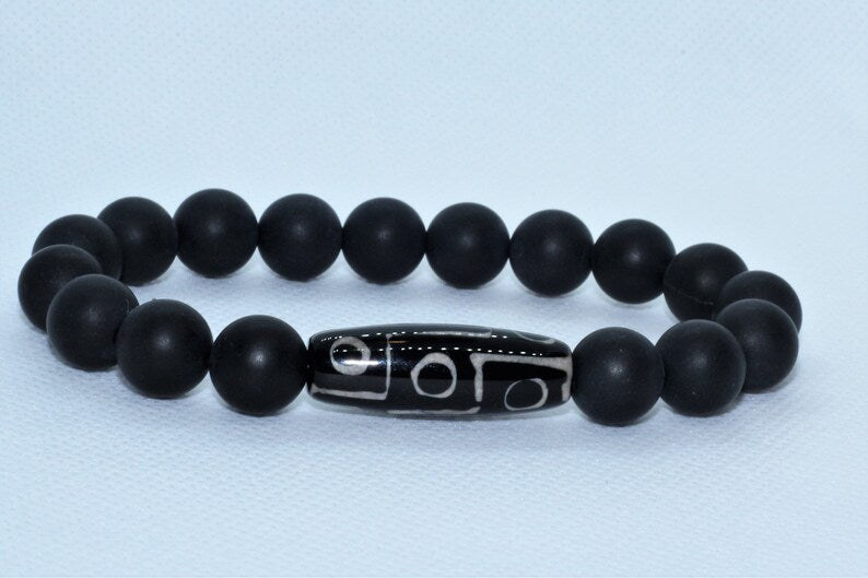 Black Onyx Bracelet with Tibetan Agate accents featuring 10mm stretch beads designed for men who appreciate spiritual healing and stylish jewelry. This handcrafted bracelet combines powerful black onyx stones with earthy agate for balance, protection, and grounding energy. Ideal as a meaningful gift for him, it blends durability and comfort with a sleek, masculine design—perfect for everyday wear, meditation, or enhancing personal style with natural healing properties.