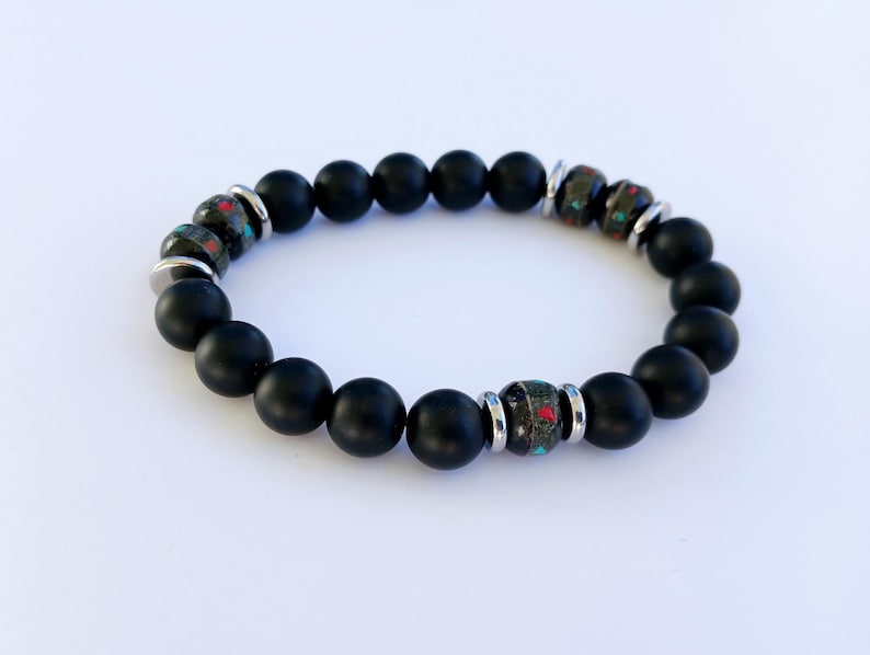 Handcrafted Onyx Bracelet for Men featuring yak bone, natural stone, and black lava beads. This minimalist Tibetan protection bracelet offers spiritual grounding and energy balance. Stylish yet meaningful, the black charm jewelry makes a unique handmade gift for men. Ideal for daily wear or special occasions, it combines tradition and modern design. Perfect men’s accessory for wellness, mindfulness, and style.