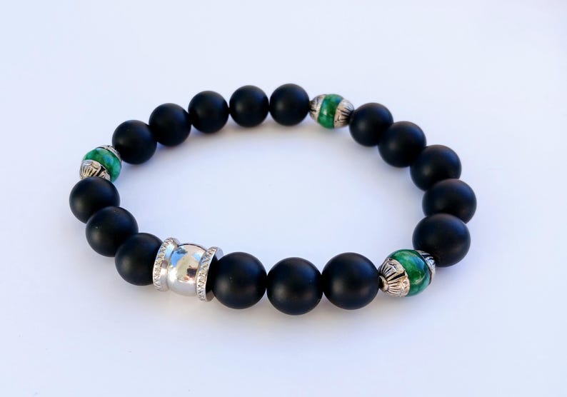 Natural Jade and Black Onyx Bracelet handcrafted as a men’s lucky charm and protection armband. This healing jewelry piece combines smooth jade and powerful black onyx stones, designed for strength, balance, and spiritual protection. Perfect handmade gift for him, ideal for birthdays, anniversaries, or wellness gifts. Stylish and meaningful, this men’s stretch bracelet blends natural energy with everyday wearable craftsmanship.