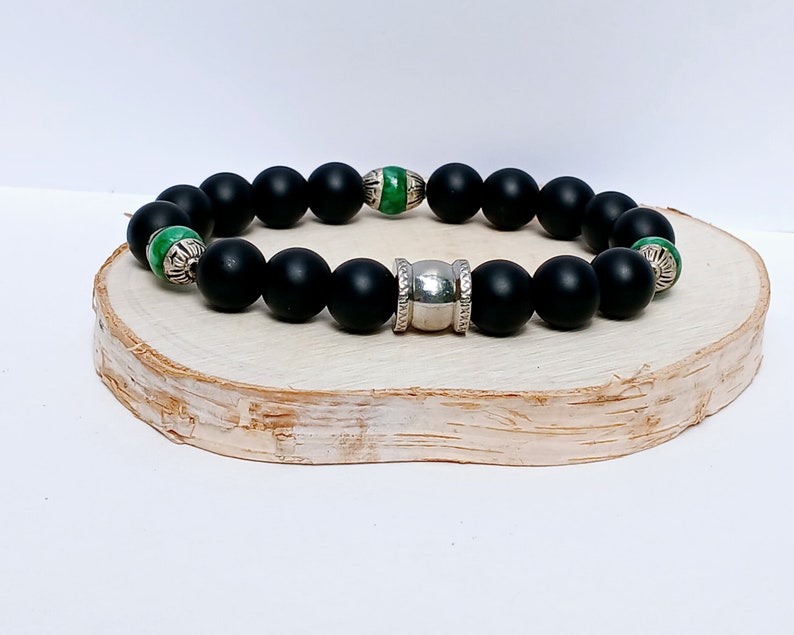Natural Jade and Black Onyx Bracelet handcrafted as a men’s lucky charm and protection armband. This healing jewelry piece combines smooth jade and powerful black onyx stones, designed for strength, balance, and spiritual protection. Perfect handmade gift for him, ideal for birthdays, anniversaries, or wellness gifts. Stylish and meaningful, this men’s stretch bracelet blends natural energy with everyday wearable craftsmanship.