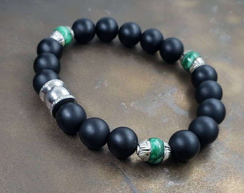 Natural Jade and Black Onyx Bracelet handcrafted as a men’s lucky charm and protection armband. This healing jewelry piece combines smooth jade and powerful black onyx stones, designed for strength, balance, and spiritual protection. Perfect handmade gift for him, ideal for birthdays, anniversaries, or wellness gifts. Stylish and meaningful, this men’s stretch bracelet blends natural energy with everyday wearable craftsmanship.
