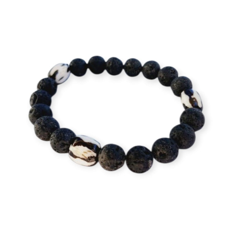 Tibetan Bone Bracelet with 12mm black lava stone beads, designed as a stretch diffuser bracelet for meditation and grounding. This handmade men’s bracelet combines traditional Tibetan jewelry elements with natural lava stones, perfect for essential oils. A meaningful lucky charm and spiritual accessory, ideal for promoting calm and focus. Great handmade gift for him—perfect for yoga, wellness, or daily wear with intention and style.