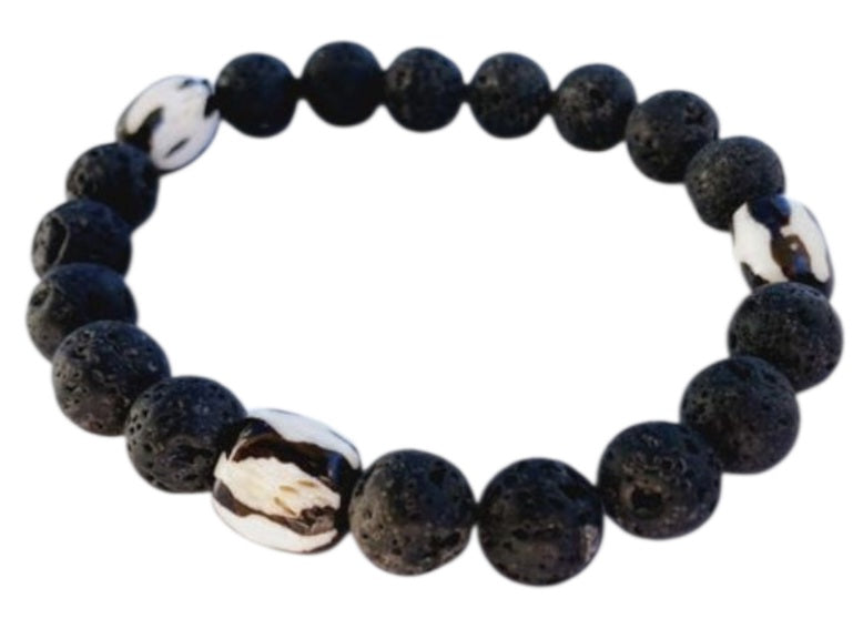 Tibetan Bone Bracelet with 12mm black lava stone beads, designed as a stretch diffuser bracelet for meditation and grounding. This handmade men’s bracelet combines traditional Tibetan jewelry elements with natural lava stones, perfect for essential oils. A meaningful lucky charm and spiritual accessory, ideal for promoting calm and focus. Great handmade gift for him—perfect for yoga, wellness, or daily wear with intention and style.